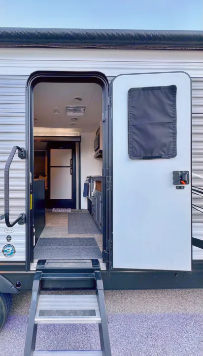 Inside an RV rental! The open door reveals steps, kitchen area, and interior beyond. Perfect for your next adventure.. Heartland RVs Trail Runner 2020