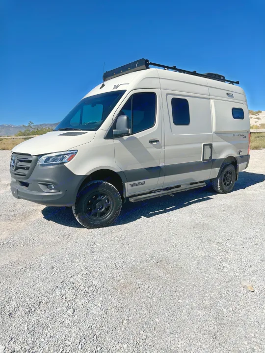 Winnebago Revel camper van, ideal rv rental for adventure, parked on gravel under a clear sky.. Mercedes Revel 2024