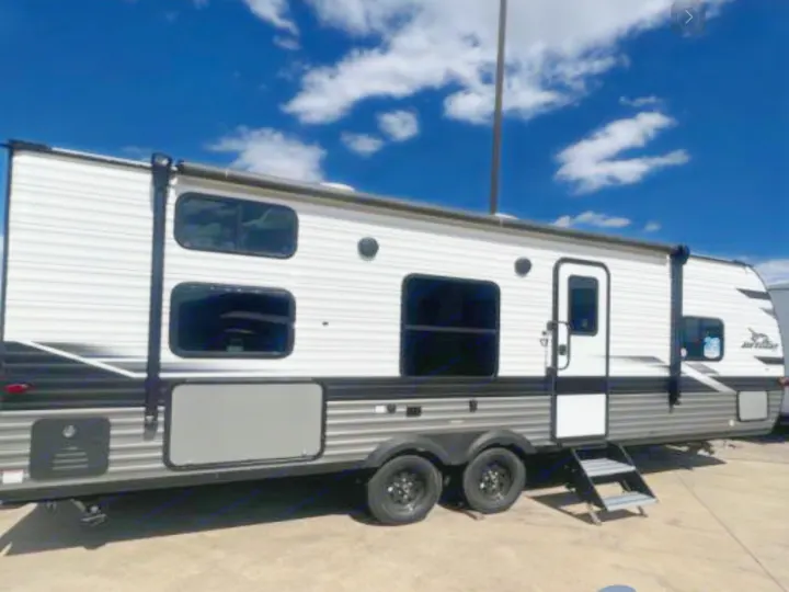 This spacious white & gray Jayco travel trailer, ideal for rv rental, features an awning, multiple windows, and entry steps.. Jayco Jay Flight 264BH 2024