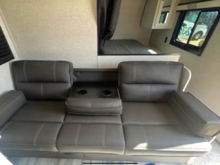 RV rental interior: Dark gray sofa with cuph. Jayco Jay Flight 264BH 2024