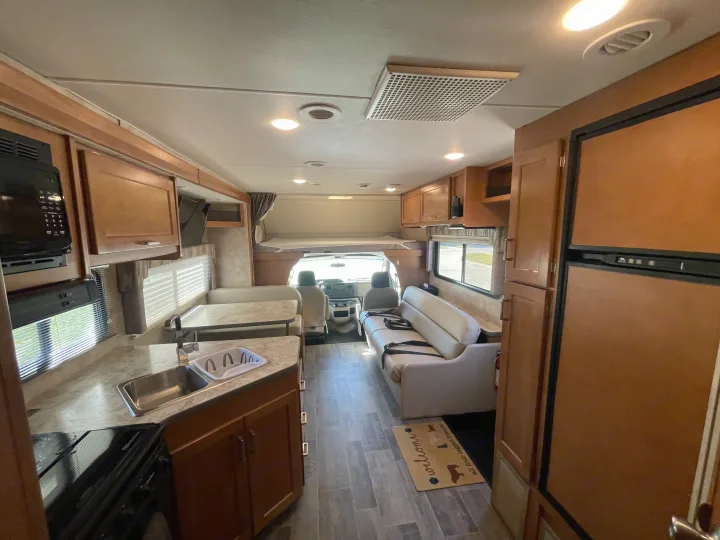 Spacious RV rental interior featuring kitchen, dinette, and living area, offering a cozy travel experience.. Winnebago Minnie Winnie 2019