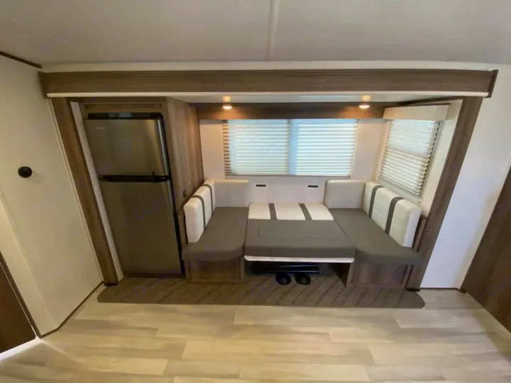 This RV rental features a modern interior: stainless steel fridge, U-shaped dinette, and bright windows.. Cruiser RV MPG Ultra Lite 2022