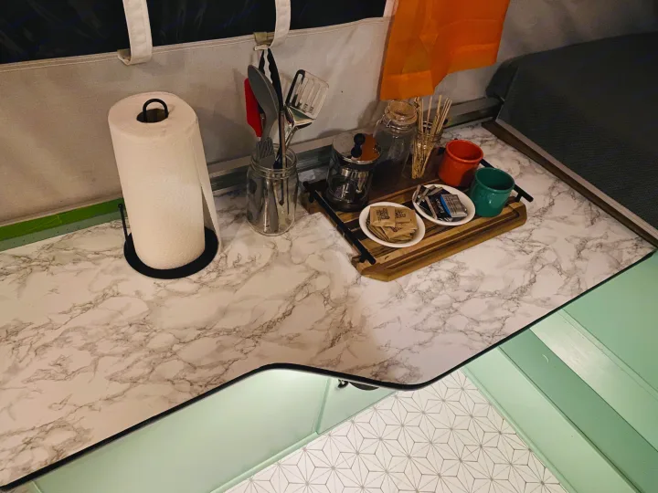 Organized RV rental kitchen counter with coffee supplies, utensils, and paper towels, perfect for travel.. Viking Recreational Vehicles, INC. Model 548 2000
