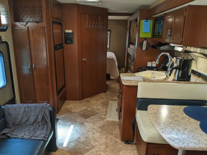Modern RV rental interior with compact kitchen, dining, and living areas for comfortable travel.. Thor ACE 30.2 2015