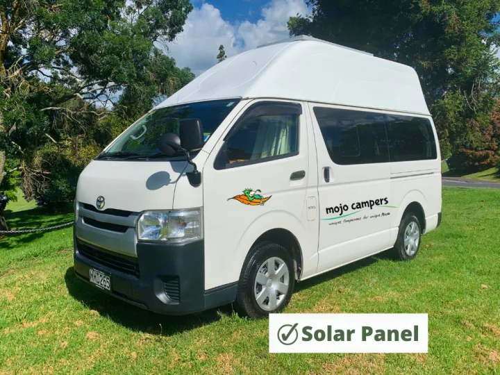 White Toyota Hiace campervan with a high roof and solar panel, available for rv rental adventures.. Toyota Hiace 2014