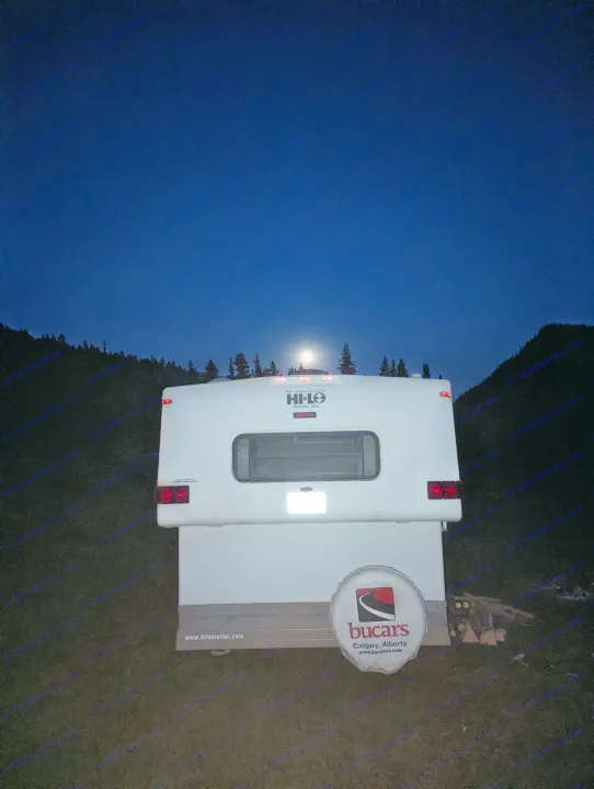 Nighttime view of a Hi-Lo RV rental under a bright moon, perfect for an outdoor adventure.. Hi Lo 2307c 2007