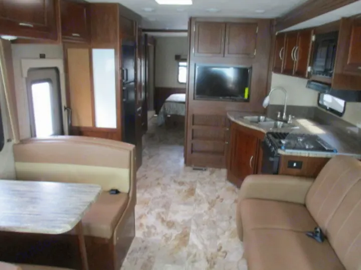 RV rental interior: full kitchen, dinette, sofa, TV, and back bedroom.. Forest River Coachmen Pursuit 2017