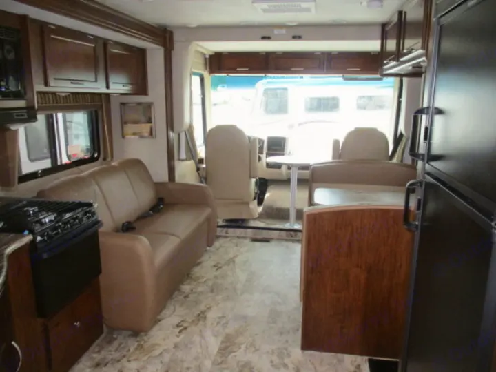 Spacious rv rental interior showing a comfortable living area, kitchen, dining, and front cockpit views.. Forest River Coachmen Pursuit 2017