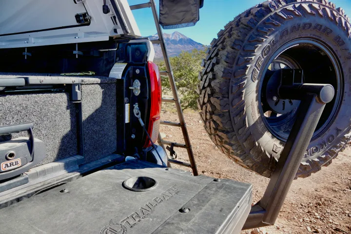 Truck bed with ARB gear, swing-out spare tire, and ladder for an RV rental outdoor adventure.. toyota tacoma trd 4x4 2018