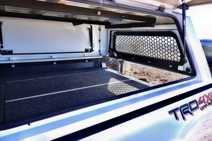 View inside an off-road truck camper, featuring a carpeted floor and a mesh window. Great for rv rental.. toyota tacoma trd 4x4 2018