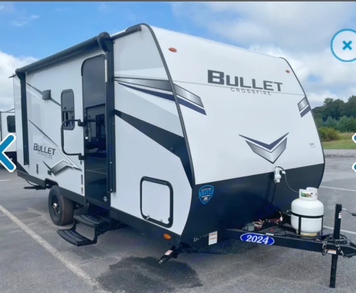 White 2024 Bullet Crossfire travel trailer RV rental, featuring an awning and front propane tank.. Keystone RV Bullet Crossfire 2024