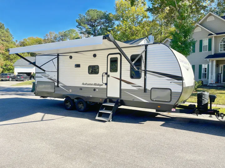 Autumn Ridge travel trailer RV rental, with an extended awning, ready for outdoor adventures.. Starcraft Autumn Ridge 2023