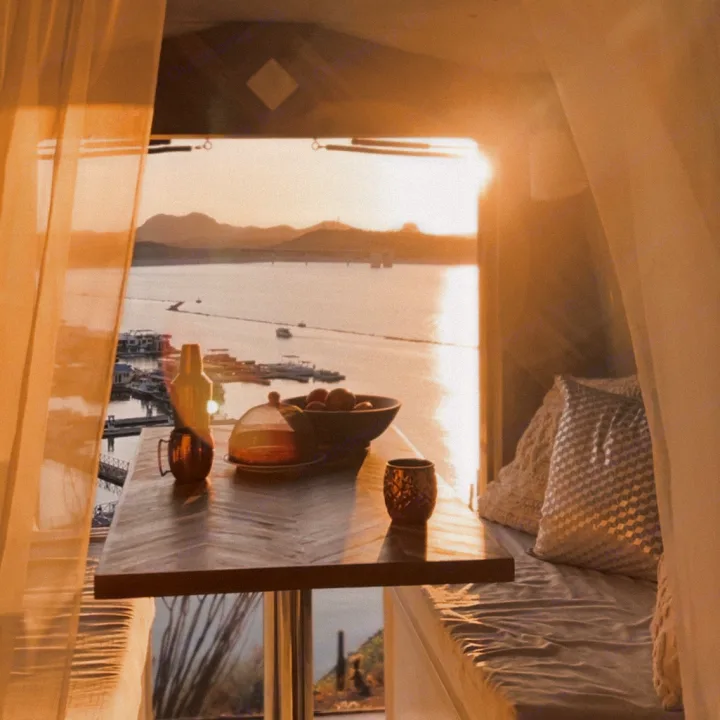 Golden hour from a comfy rv rental! Enjoy a serene lake sunset view from this cozy dining nook.. Ford E450 1999