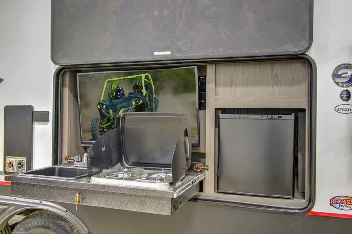 RV rental with outdoor kitchen featuring TV, sink, stove, and fridge for ultimate camp living.. Cruiser Rv Corp Stryker 2022