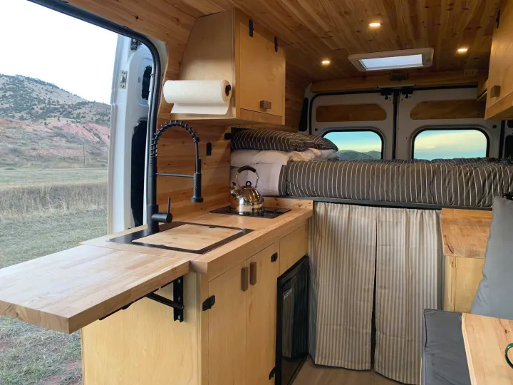 Step inside this cozy RV rental, a converted camper van with a fully equipped kitchen, comfy bed, and views of the mountains.. RAM Promaster 2500 159wb 2018