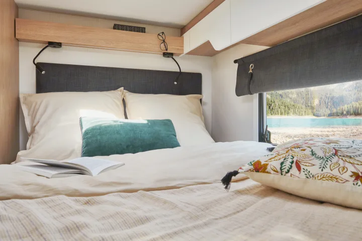 Relax in this RV rental's comfy bedroom, waking up to beautiful lake and forest views.. PILOTE A696G Atlas 2025