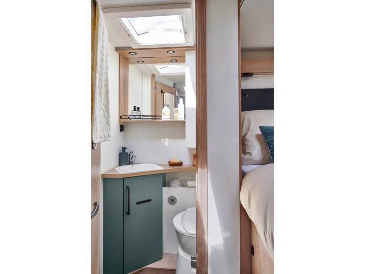 Inside a cozy rv rental: modern RV bathroom with skylight, sink, toilet, and adjacent bedroom.. PILOTE A696G Atlas 2025