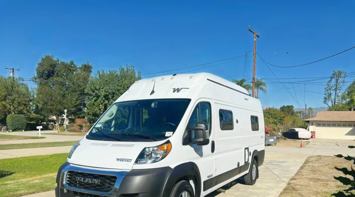 A white Winnebago camper van, ideal for your next RV rental adventure. Parked on a sunny driveway.. Winnebago Solis 2023
