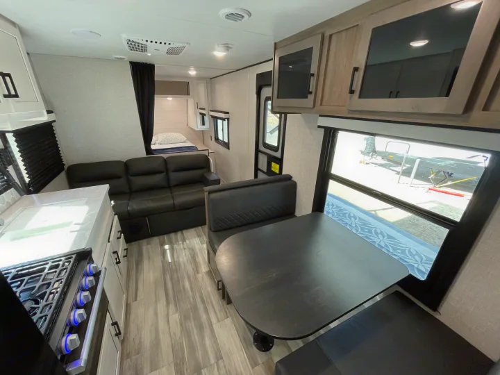 Spacious RV rental interior featuring kitchen, living, dining areas, and a cozy bedroom. Perfect for your next trip!. Jayco Jay Flight 2024