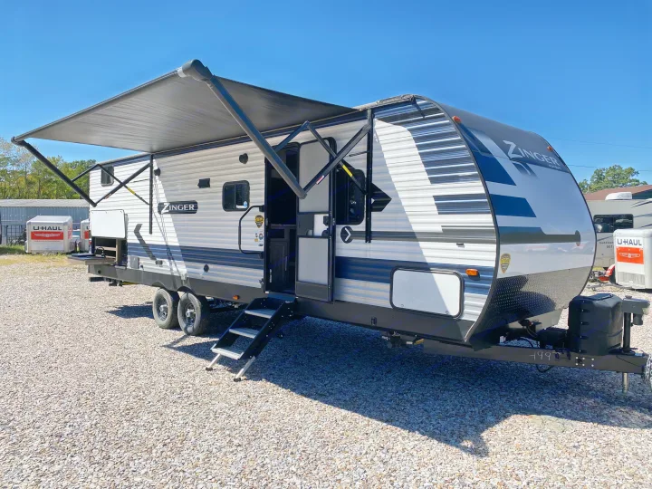 Explore the outdoors! This Zinger travel trailer RV rental, with an extended awning and outdoor kitchen, is ready for adventure.. Keystone Crossroads Zinger 2021