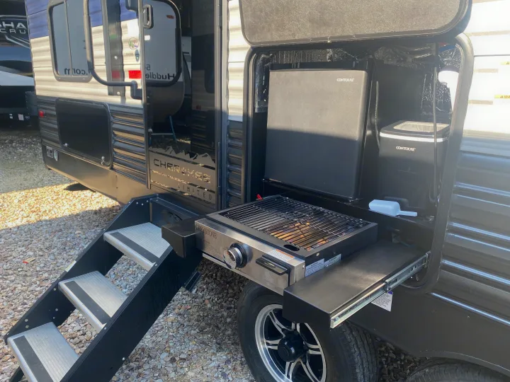 This **RV rental** features a convenient outdoor kitchen with a Greystone grill, Contoure mini-fridge, and ice maker, with steps.. Forest River Cherokee 2021