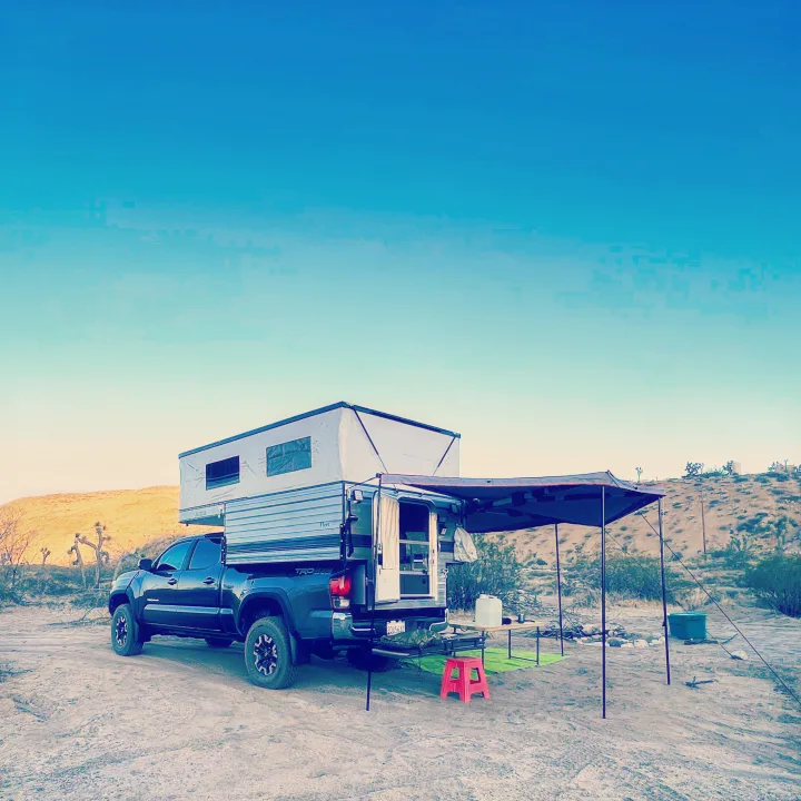 Explore the desert with this truck camper RV rental setup, perfect for off-grid camping adventures.. Four Wheel Campers Fleet 2021