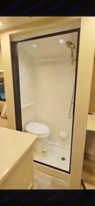 RV rental interior: A compact, all-in-one bathroom with a toilet, shower, and toilet paper holder.. Cahaba Cahaba Class B 2022