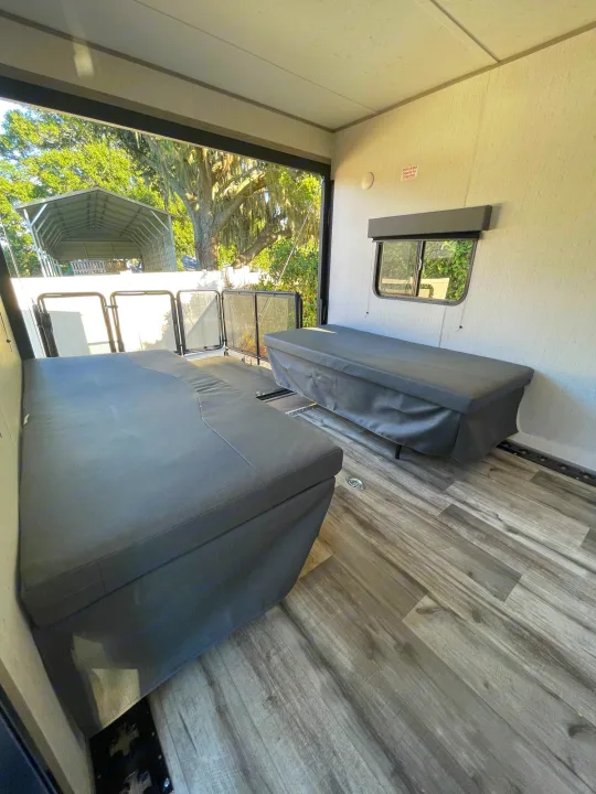RV rental: Bright toy hauler interior with ample cargo space, convertible bench seating, and rear patio deck.. Coleman Other 2022