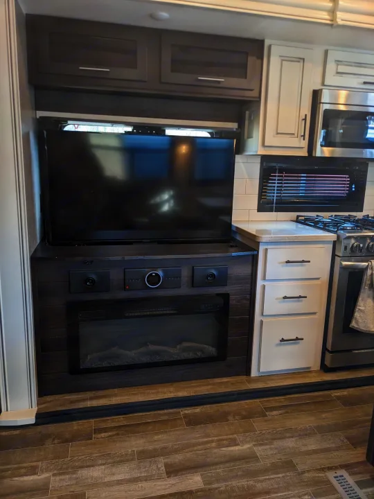 Experience comfort in this RV rental with a built-in entertainment center, electric fireplace, and complete kitchen amenities.. Jayco North Point 2021