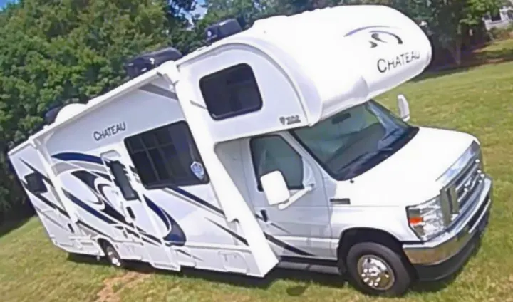 White Chateau RV rental: A Class C motorhome with sleek blue/grey graphics, ready for your travel adventure.. Thor Chateau Victory 2022