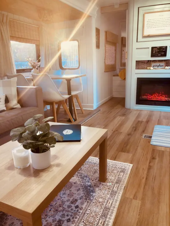 Cozy and modern RV rental living space featuring a dining area, sofa, and inviting fireplace.. Forest River Other 2013