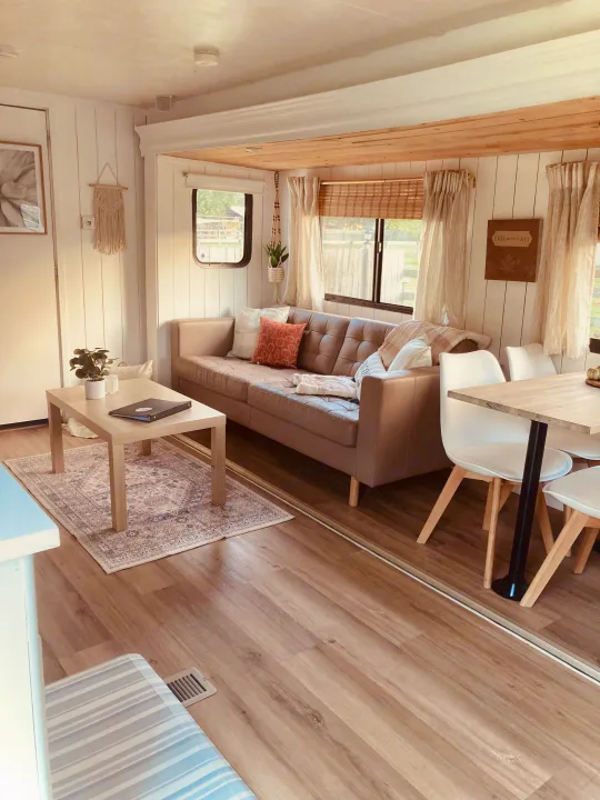 Bright RV rental living & dining area with shiplap walls, wood floors, and neutral furnishings.. Forest River Other 2013