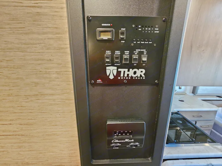 RV rental control panel featuring generator, slide-out, tank level, water heater, and thermostat controls.. Thor Motor Coach Freedom Elite 2021