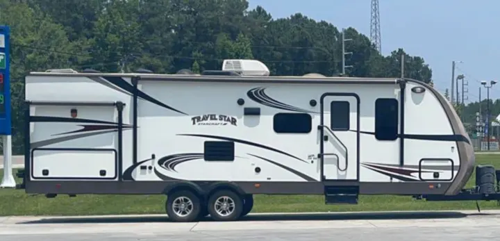 A large white and brown Travel Star Starcraft travel trailer, perfect for your next RV rental adventure.. Starcraft Travel Star 2016