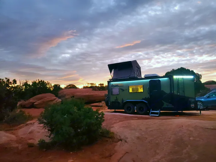XPLORE off-road RV rental under a vibrant desert sunset, perfect for remote camping and overlanding adventures.. Imperial Outdoors XploreRV 2023