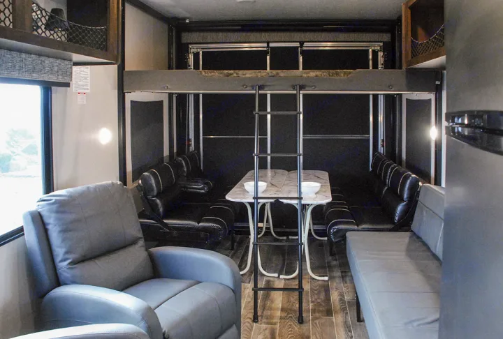 RV rental interior: a versatile living space with recliners, dining area, and upper bunk for flexible travel.. K-Z Manufacturing Sportster 2019