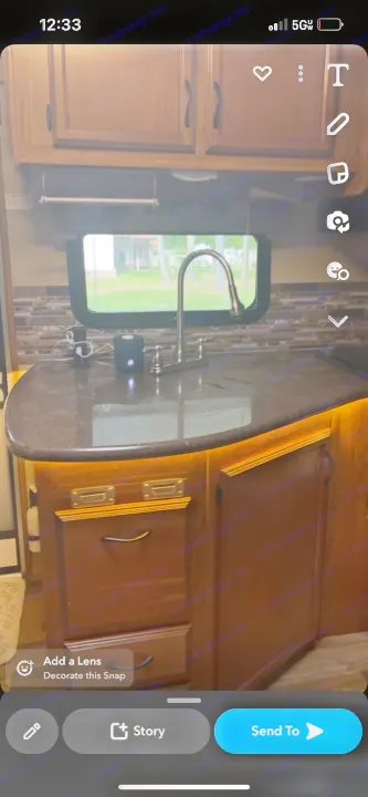 Explore this well-appointed RV rental kitchen! Features include dark counters, a modern sink, and ambient under-cabinet lighting.. Starcraft Travel Star 2016