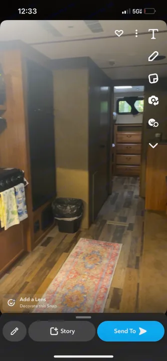 Cozy RV rental interior with kitchen, a hallway leading to a bedroom, and a colorful rug on the wood-look floor.. Starcraft Travel Star 2016