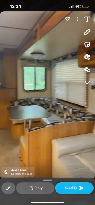 Experience an RV rental! This cozy interior features a dining area with a U-shaped booth and a window looking out at trees.. Starcraft Travel Star 2016