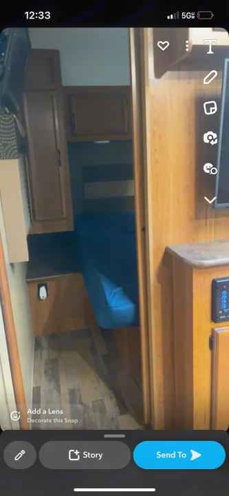 Explore this compact RV rental's interior! Features a cozy bunk bed, wooden cabinets, and integrated control panel.. Starcraft Travel Star 2016