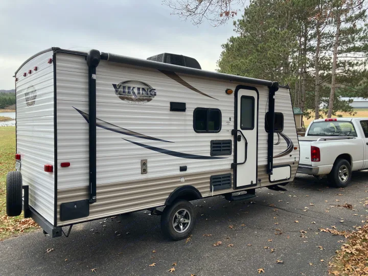 White Viking travel trailer hitched to a truck. This RV rental is ready for your next outdoor adventure!. Forest River Viking 2016