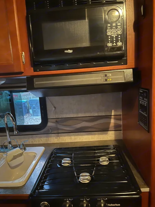 RV rental: Well-equipped kitchen with a High Pointe microwave, Suburban gas stove, sink, and vent hood.. Winnebago Winnebago 2014