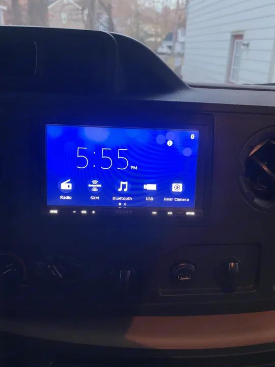 Inside an RV rental, the dash features a Sony infotainment system showing 5:55 PM, with media options and rear camera view.. Winnebago Winnebago 2014