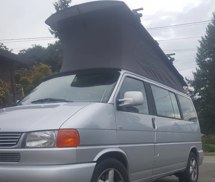 Silver VW T4 pop-top camper van, perfect for your next rv rental adventure. See its unique design.. Volkswagen Westfalia 2002