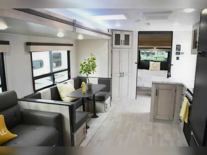 Spacious RV rental interior: bright dinette, well-equipped kitchen, and cozy bedroom in an open layout.. KZ Connect C291BHK 2023