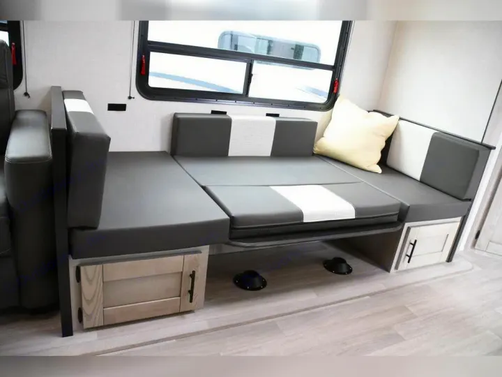 This RV rental features a convertible dinette with grey & white cushions, ideal for seating & sleeping, with handy under-bench storage.. KZ Connect C291BHK 2023
