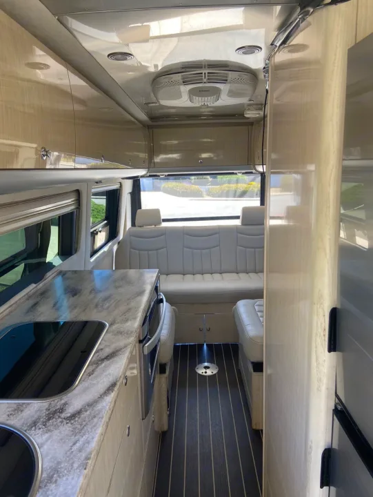 Spacious RV rental interior featuring a modern kitchen, comfortable seating, and overhead storage.. Airstream Interstate 2015