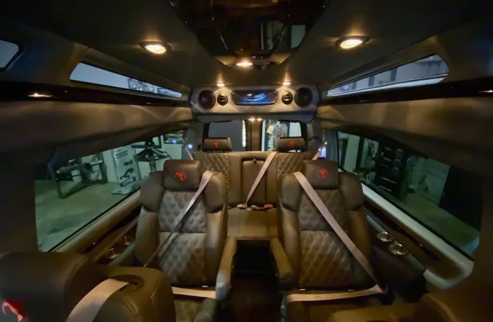 Luxury RV rental interior featuring diamond-quilted seats, ambient lighting, and entertainment system.. Passenger Van 9 Passenger Van 2024