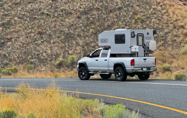 This silver pickup truck, equipped with a Scout truck camper, could be your next RV rental for remote travel.. Dodge Dodge Bighorn 3500 Heavy Duty Pu 2005