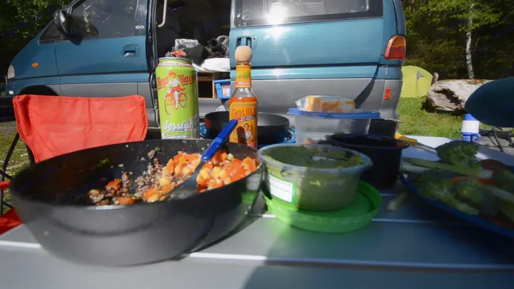 RV rental: Outdoor meal setup by a blue camper van, featuring quinoa, guacamole, veggies, hot sauce & a cold IPA.. MITSUBISHI Delica 1997